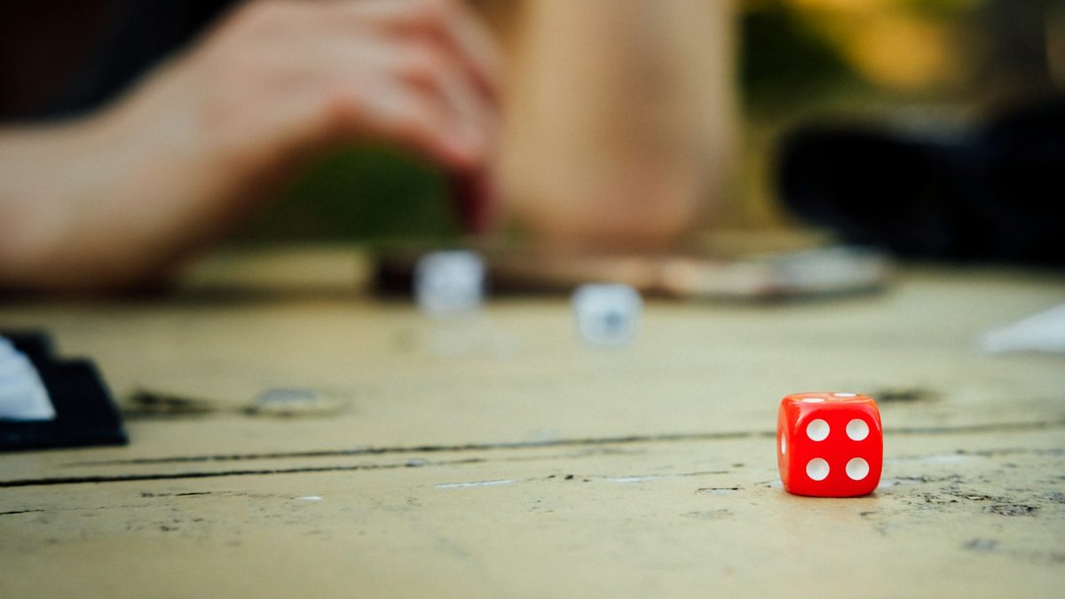 Dice beside a hand-written score sheet on a table
