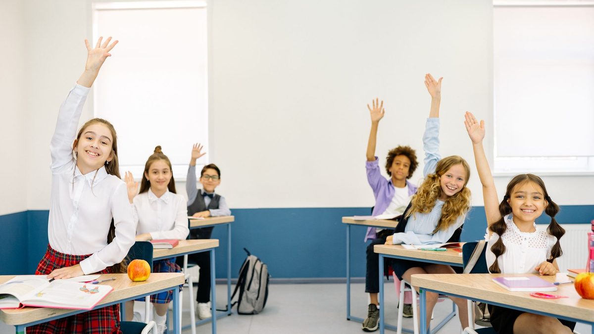 Pupils eagerly raising their hands during a short classroom brain break