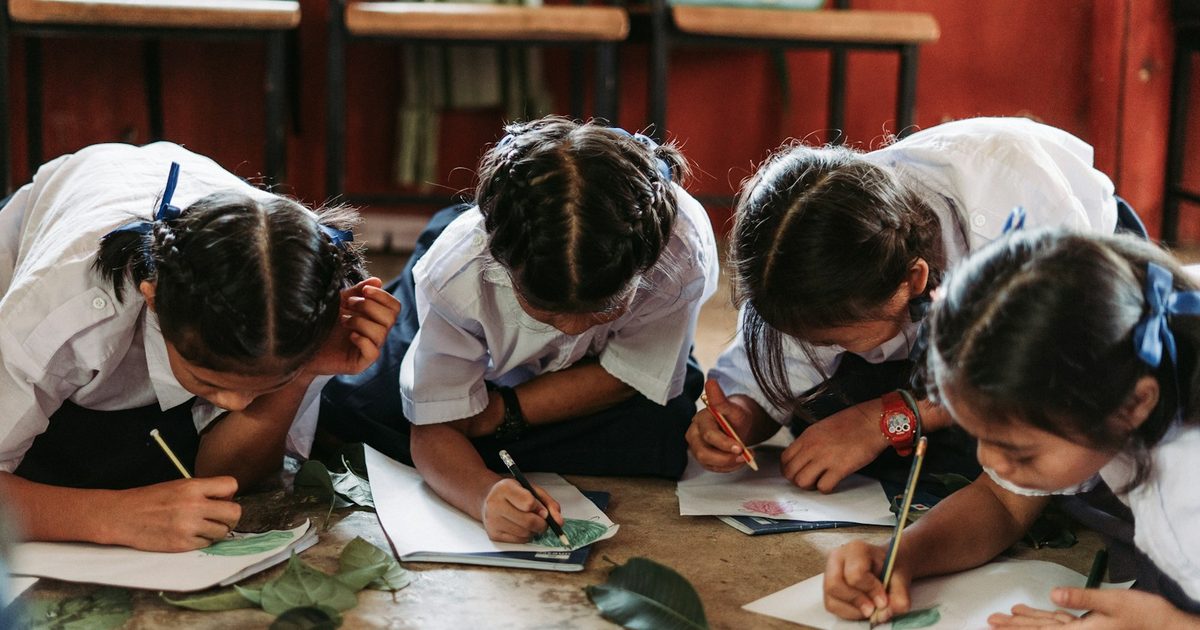 Primary school pupils working quietly on an indoor activity in a classroom