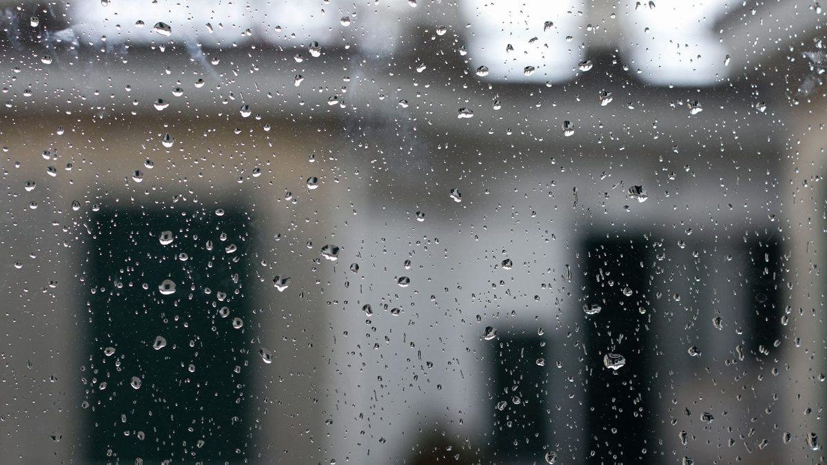 Raindrops running down a window at home on a wet day