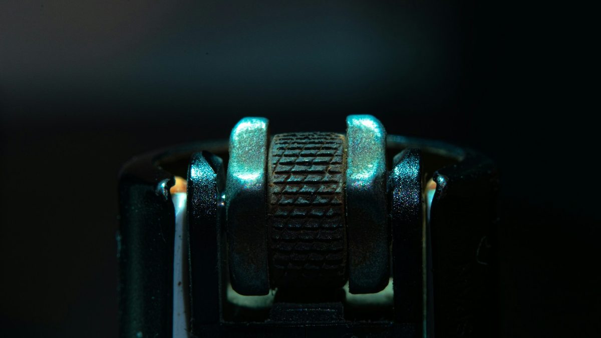 A small metal pencil sharpener showing its blade in detail