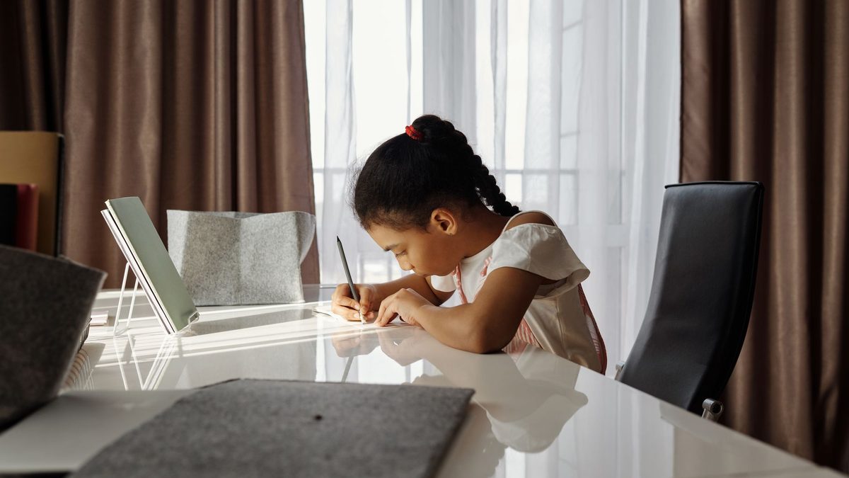 A child working alone quietly and concentrating at a desk