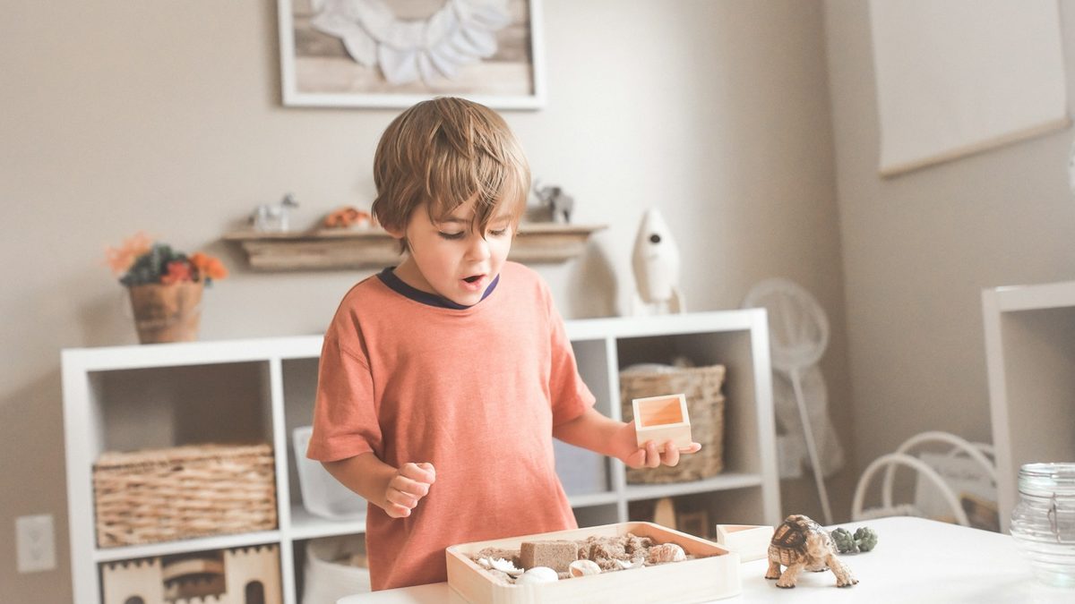 A child sorting and organising small objects into groups