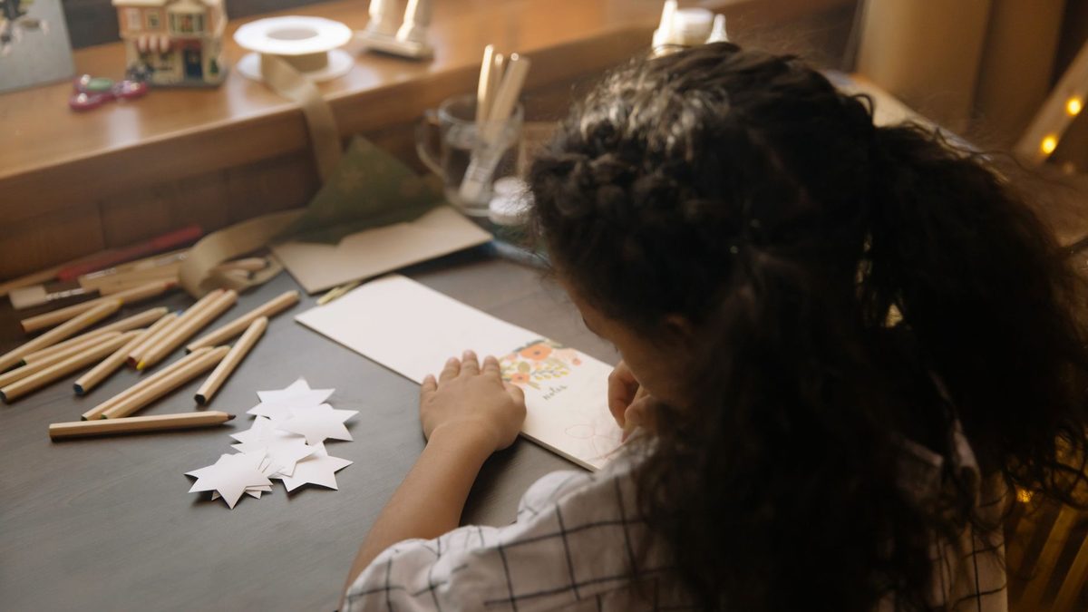 A child writing a note or card by hand