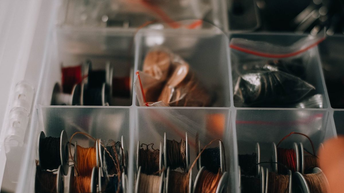 Small storage trays with compartments for organising a collection