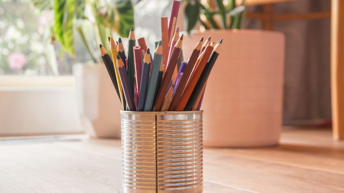 Coloured pencils stored neatly in a tin