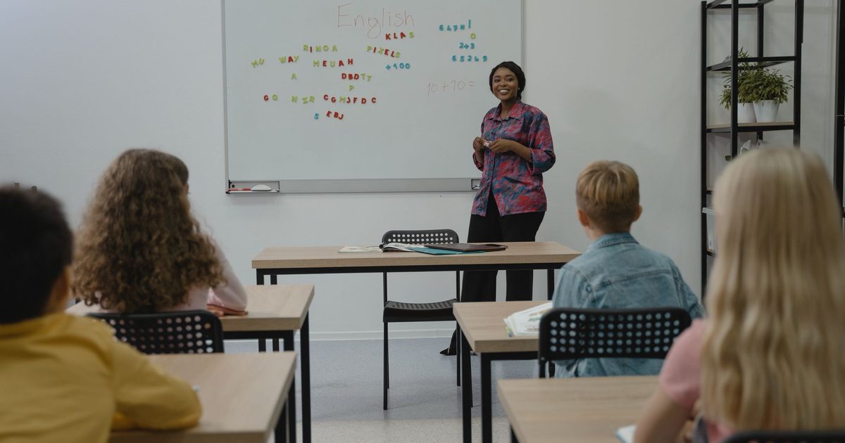 A teacher standing in front of an unfamiliar class of pupils