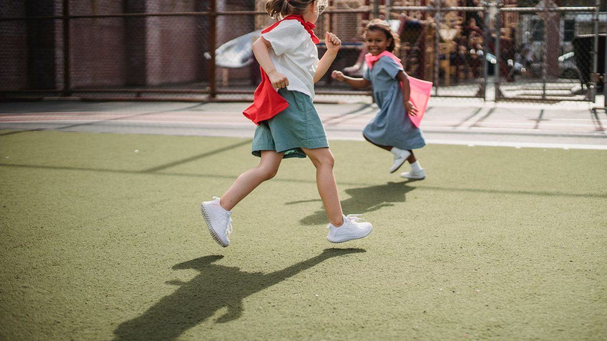 Children chasing each other and laughing outdoors