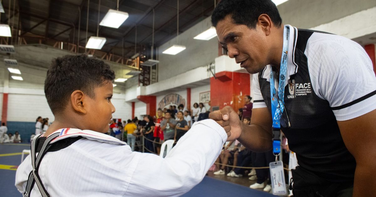 A teacher praising and rewarding a pupil in class