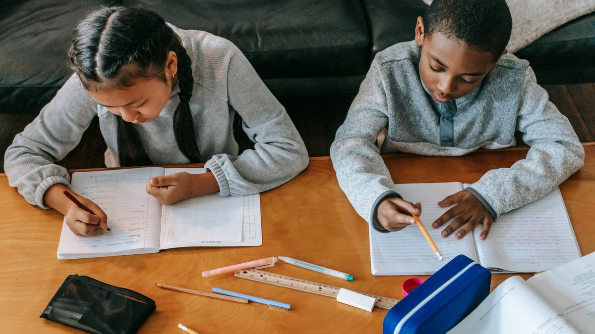 Two children cooperating together on a shared task