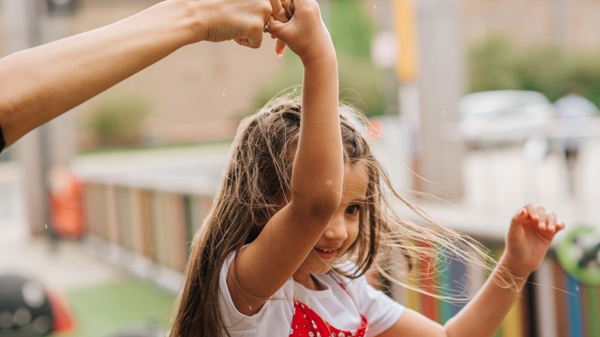 An excited child holding up something they have found