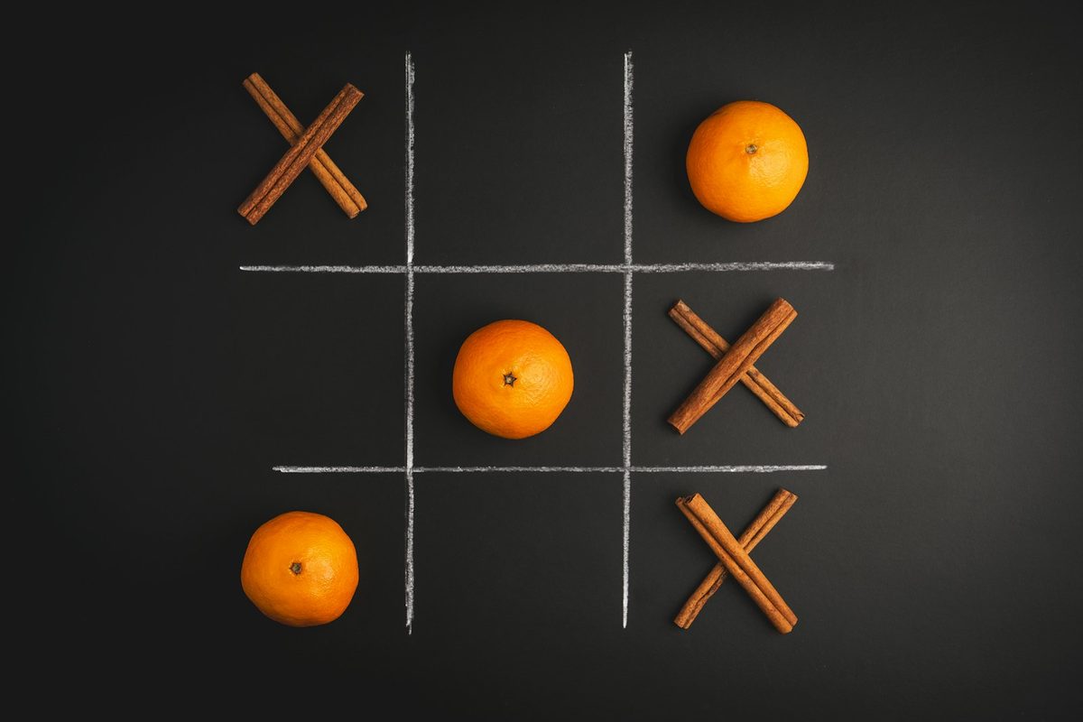 A finished game of noughts and crosses drawn on paper in pencil