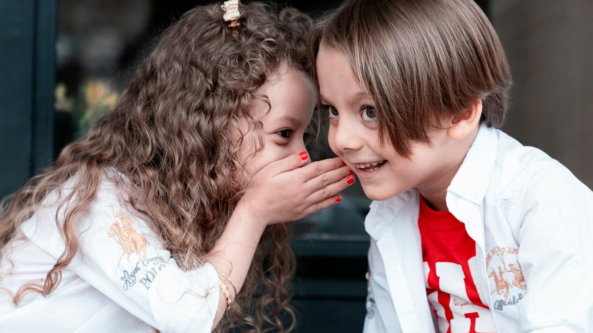 Two children exchanging and swapping items with each other