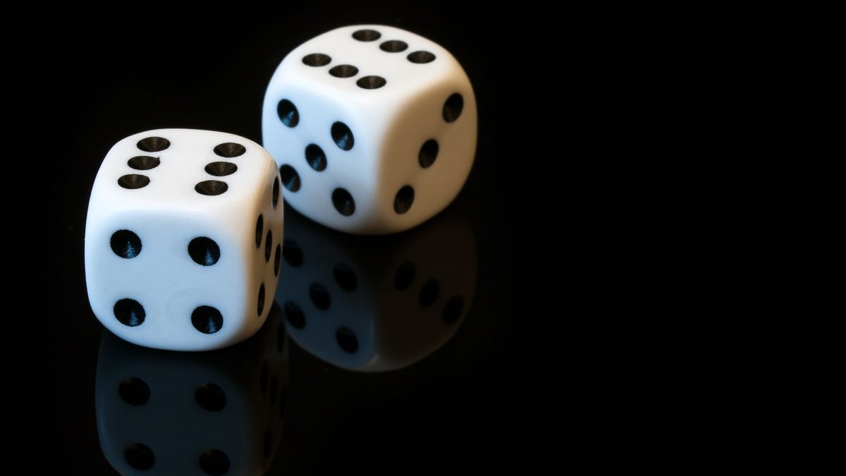 A pair of dice showing numbers on a wooden table
