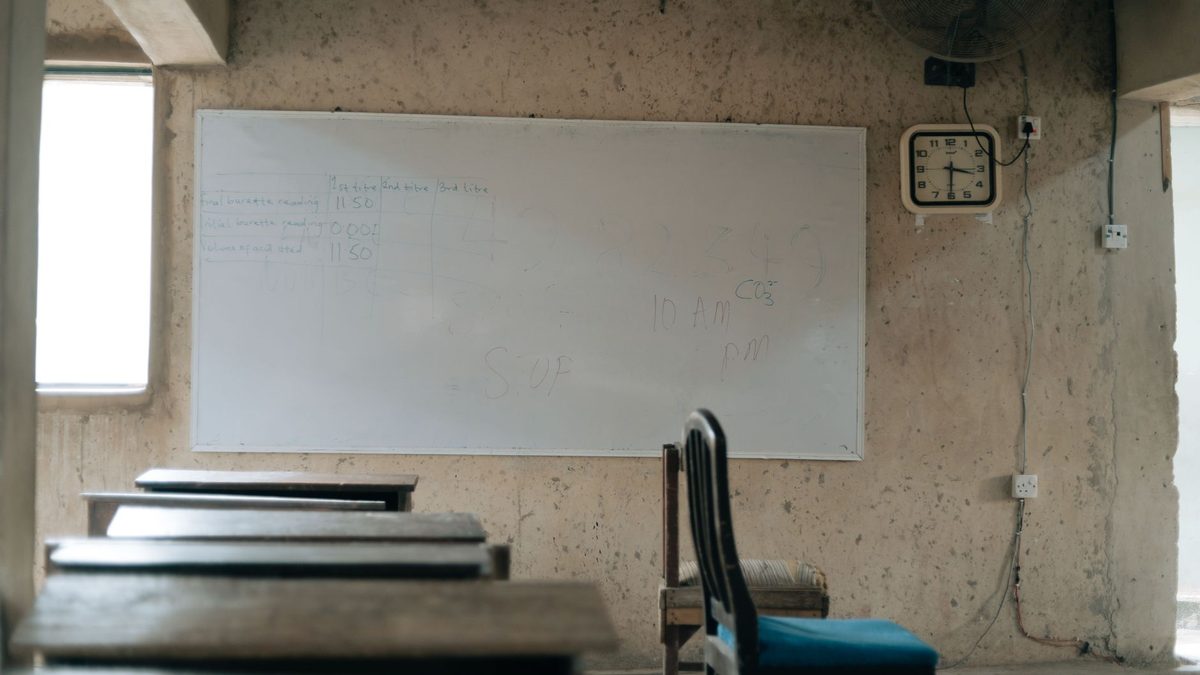 A clock on a classroom wall marking passing time