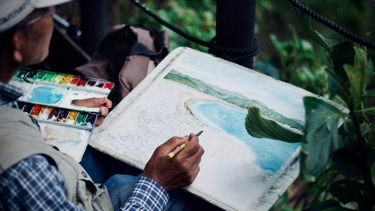 A brush being used to blend a watercolour pencil drawing