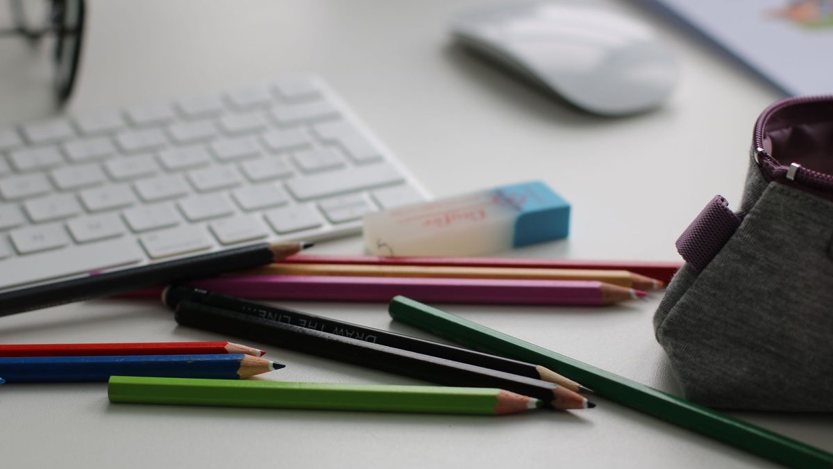 The contents of a school pencil case laid out on a desk