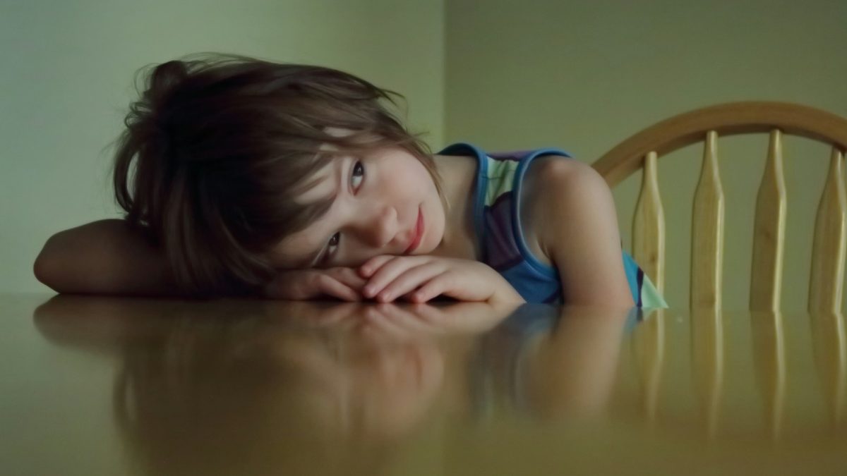 A child looking disappointed after losing a game