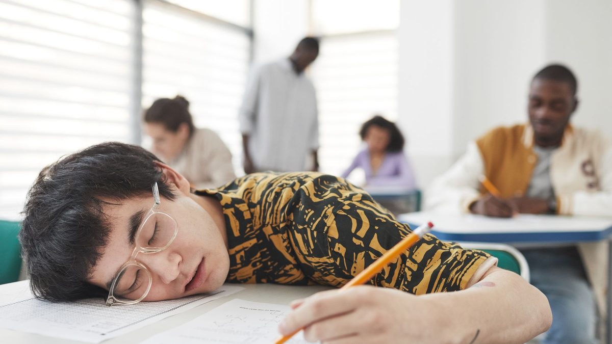 A tired pupil losing focus at their desk during a lesson