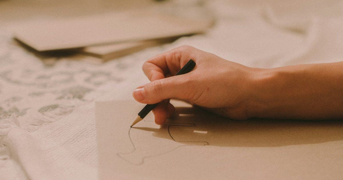 Doodles drawn by hand in the margin of a notebook